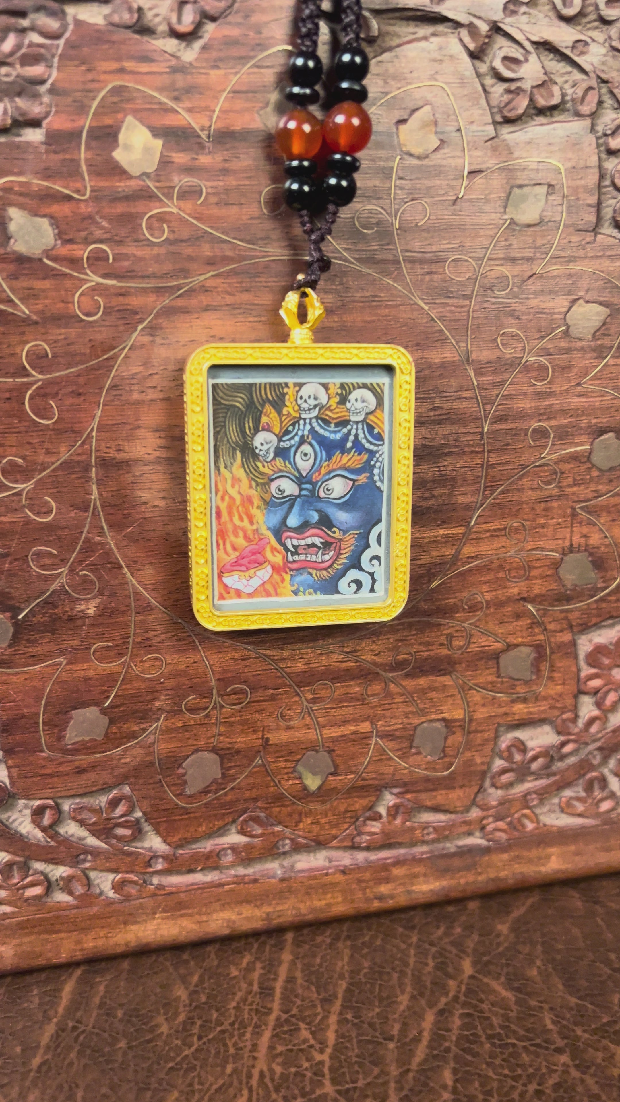 Hand-painted Mahakala miniature Thangka pendant in gold-accented copper Ghau locket with black beaded cord.