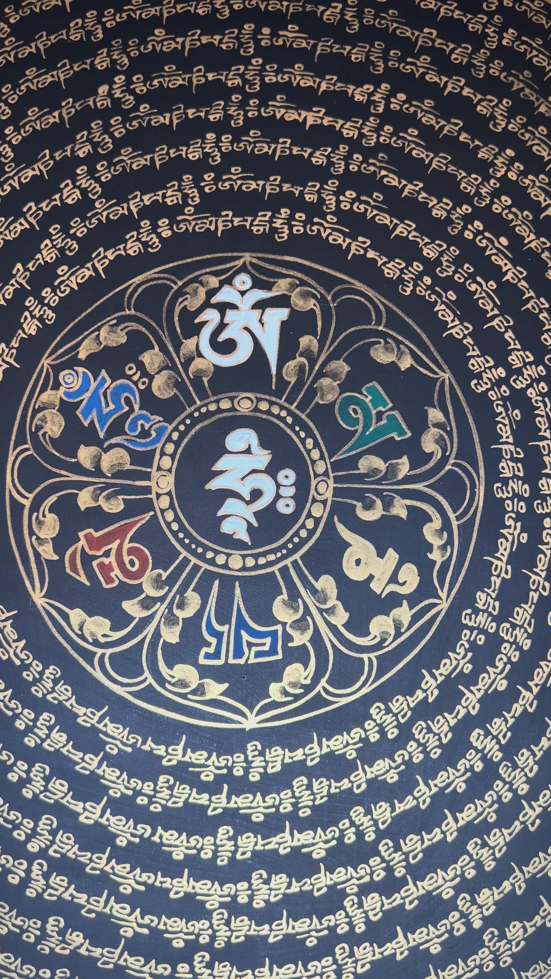 Tibetan mantra mandala thangka on black background with gold script, floral corner designs, and sacred border text.