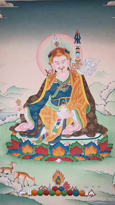 Hand-painted Guru Rinpoche thangka featuring Padmasambhava seated on a lotus throne holding vajra and skull cup within a peaceful Himalayan landscape