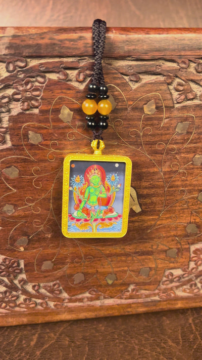 Hand-painted Green Tara miniature Thangka pendant in gold-accented copper Ghau locket with black beaded cord.
