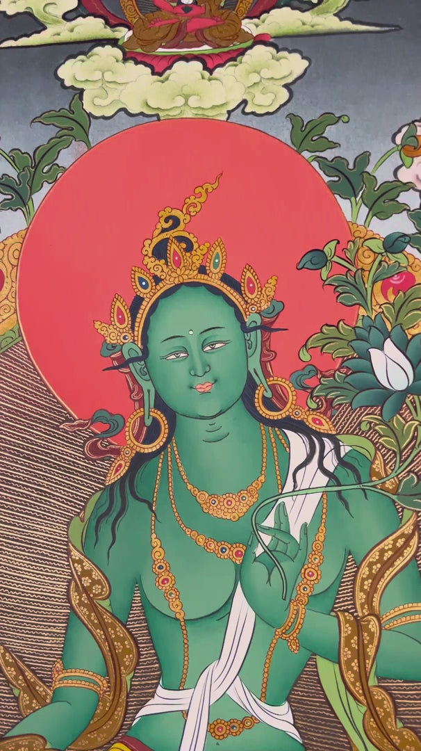 Hand-painted Tibetan Green Tara thangka featuring the Buddhist goddess seated on a lotus throne surrounded by sacred deities and floral Himalayan scenery
