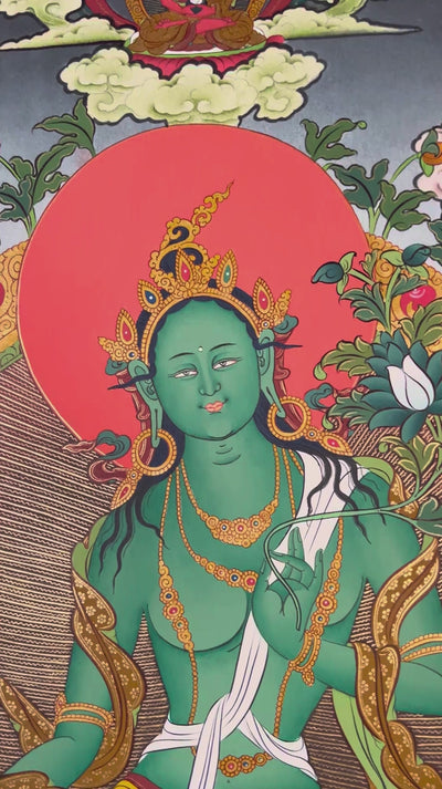 Hand-painted Tibetan Green Tara thangka featuring the Buddhist goddess seated on a lotus throne surrounded by sacred deities and floral Himalayan scenery
