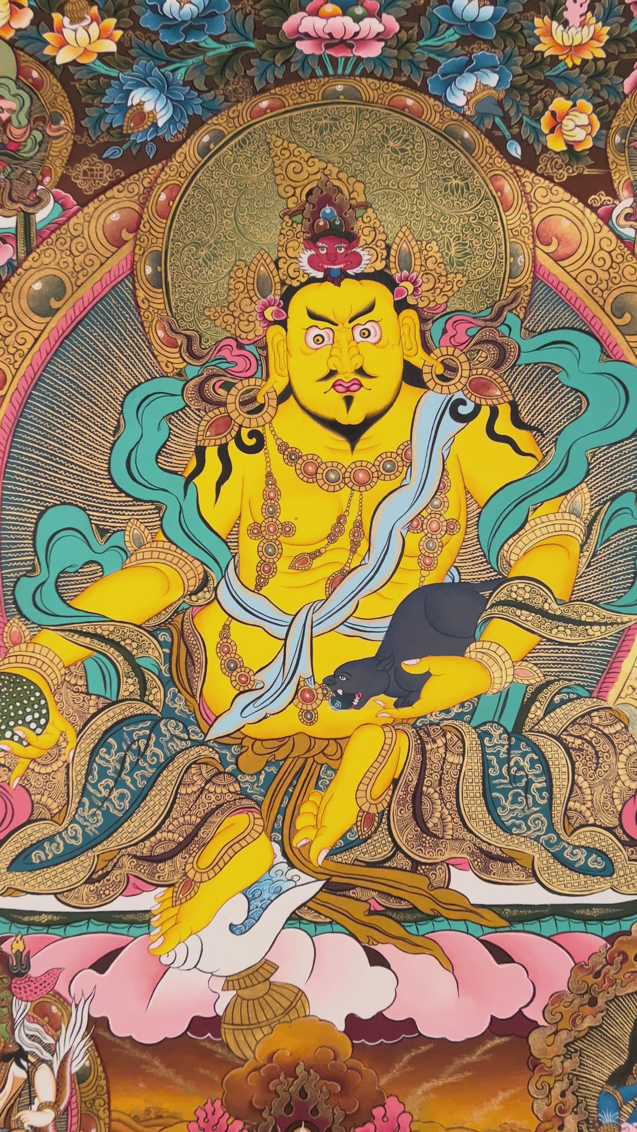Hand-painted Yellow Zambhala thangka featuring the wealth deity holding a mongoose, seated on a lotus with rich ornaments and vibrant colors.