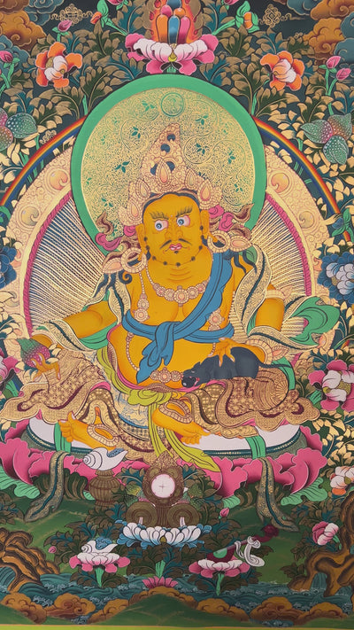 Hand-painted Yellow Zambhala thangka showing wealth deity seated on lotus with mongoose and rainbow halo.