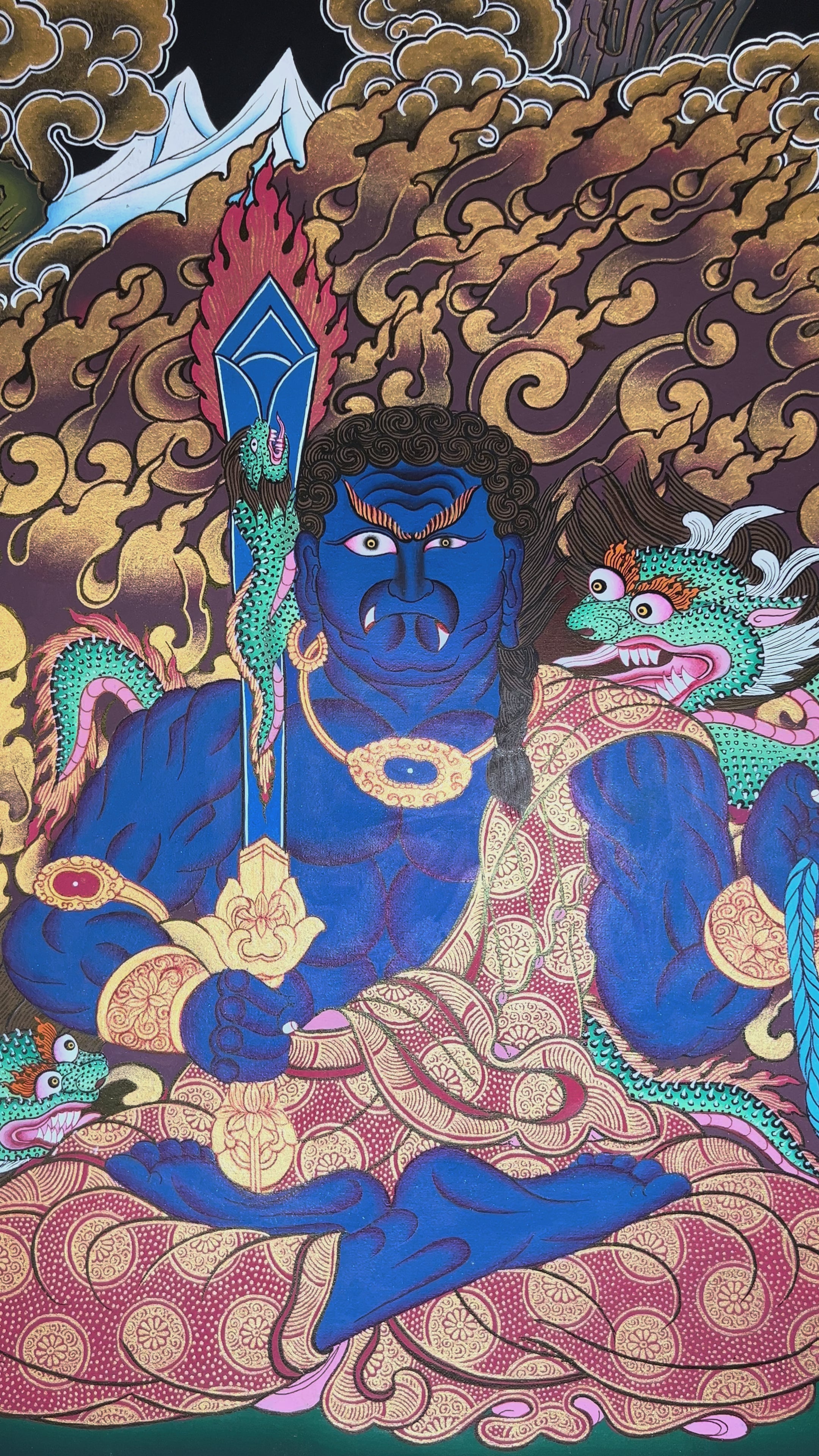 Yamaraj thangka showing a blue wrathful deity holding a staff and noose, seated in a powerful posture surrounded by golden clouds in Tibetan style.
