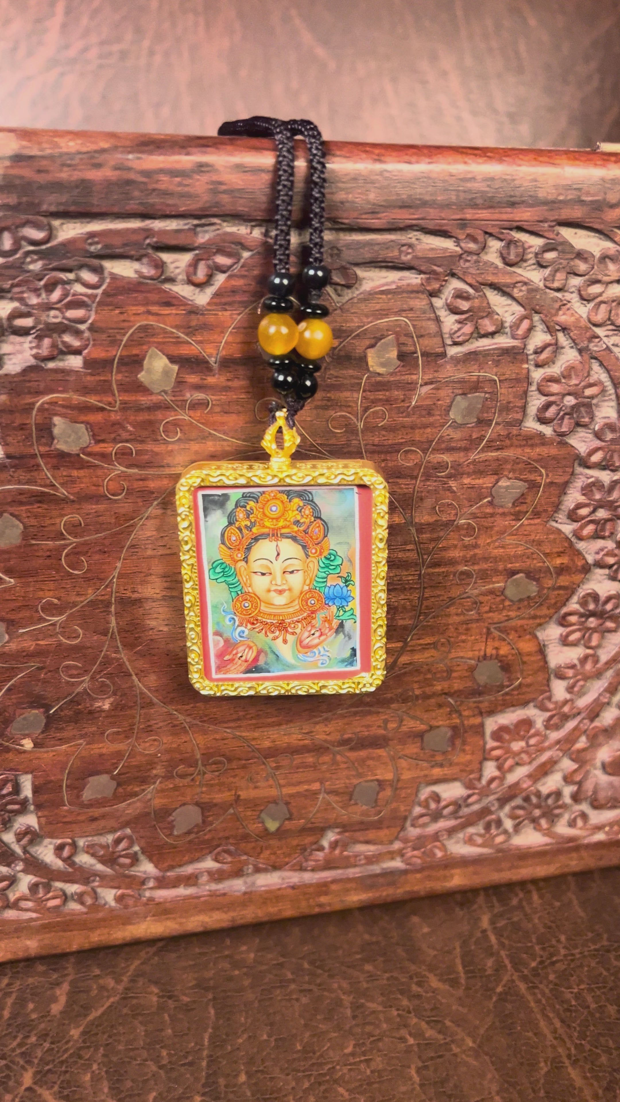Hand-painted White Tara miniature Thangka pendant in gold-accented copper Ghau locket with black beaded cord.