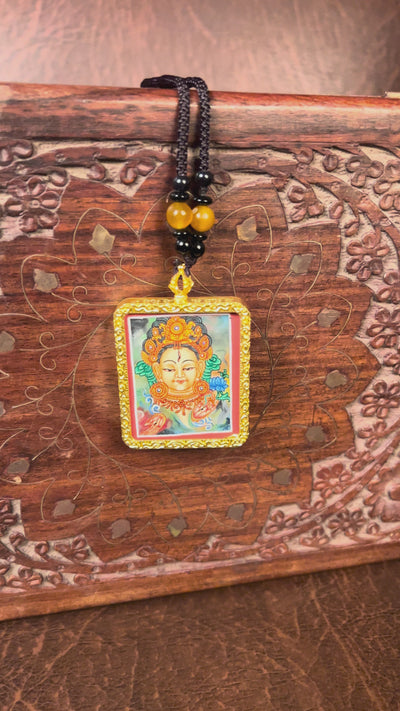 Hand-painted White Tara miniature Thangka pendant in gold-accented copper Ghau locket with black beaded cord.
