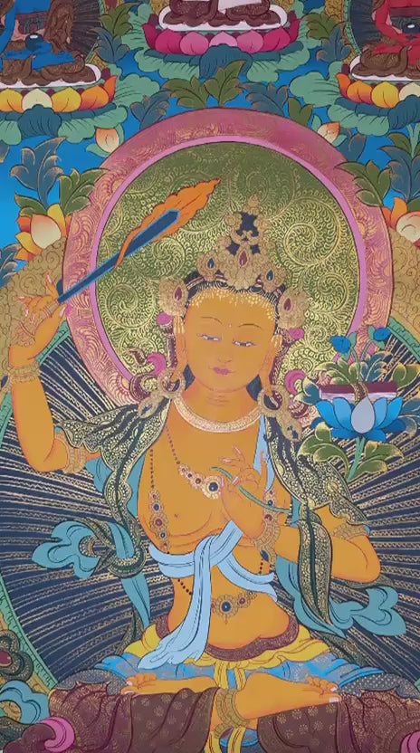  Manjushree thangka featuring the  wisdom deity holding a flaming sword and sacred scripture surrounded by Buddhas, lotus flowers, and ornate gold detailing