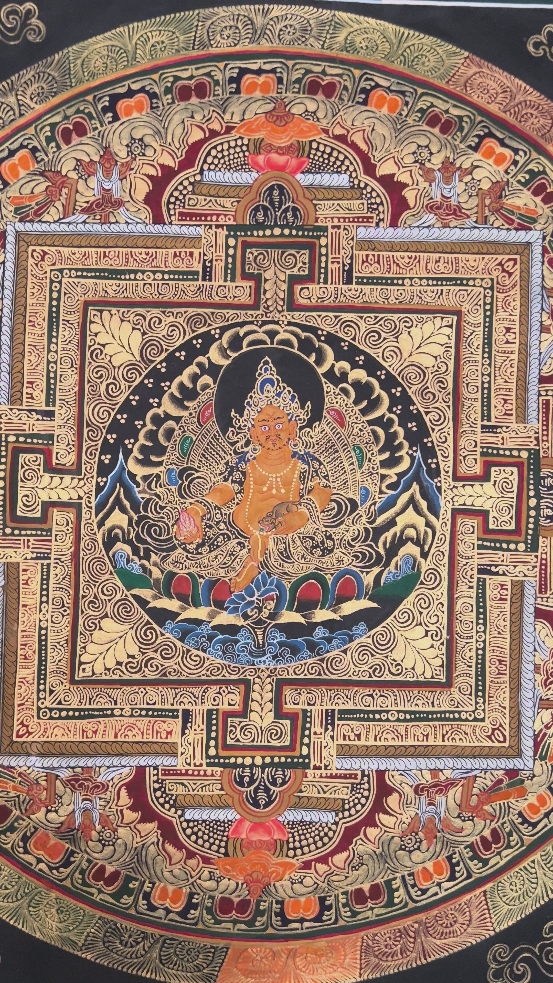 Hand painted Zambhala Mandala thangka depicting Tibetan wealth deity seated within sacred geometric palace on black background
