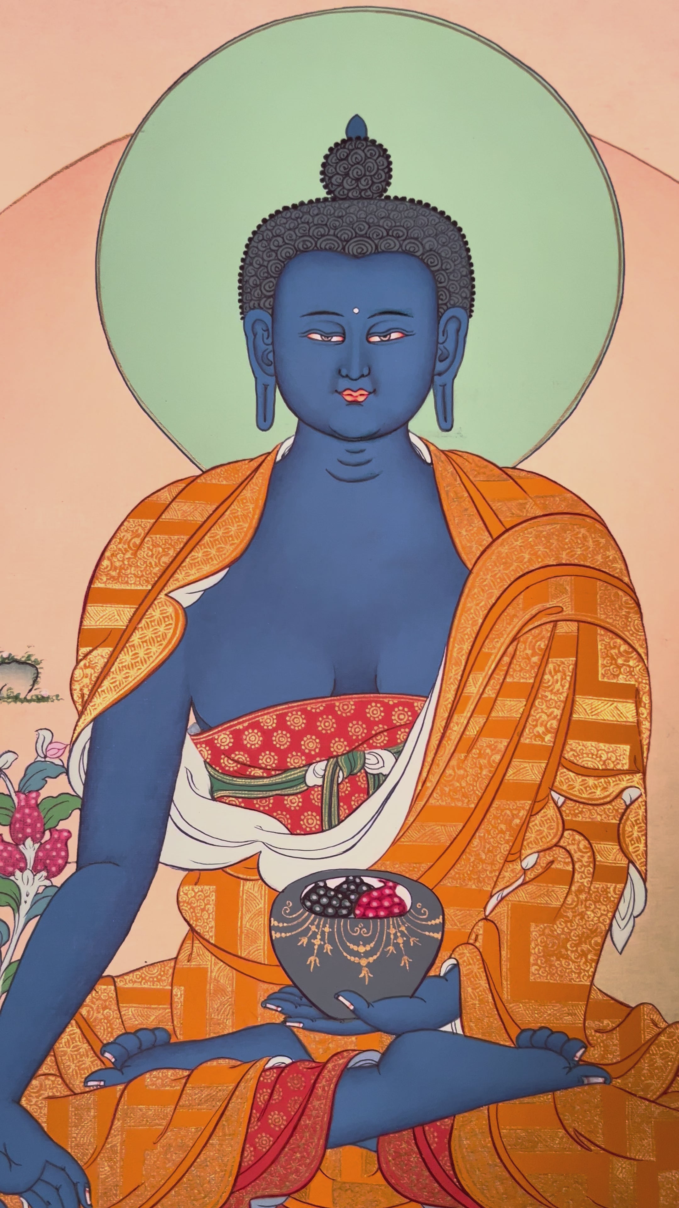 Medicine Buddha thangka showing a blue Buddha seated on a lotus holding a healing bowl, with a calm halo and peaceful landscape.