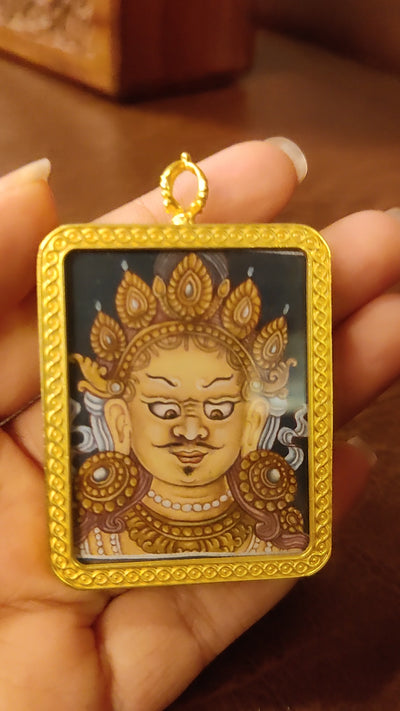 Yellow Zambhala Ghau pendant in a decorative gold-tone frame featuring a miniature Tibetan Buddhist wealth deity artwork handcrafted in Nepal.