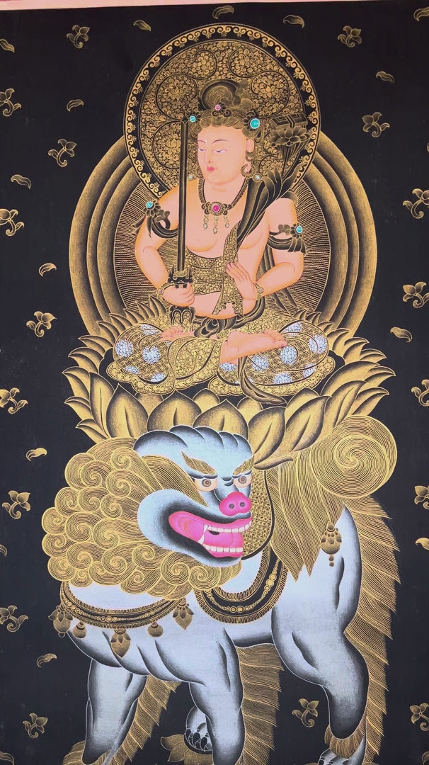 Hand-painted Manjushri thangka in gold on black canvas featuring the Buddhist wisdom deity seated on a snow lion holding a flaming sword and lotus scripture
