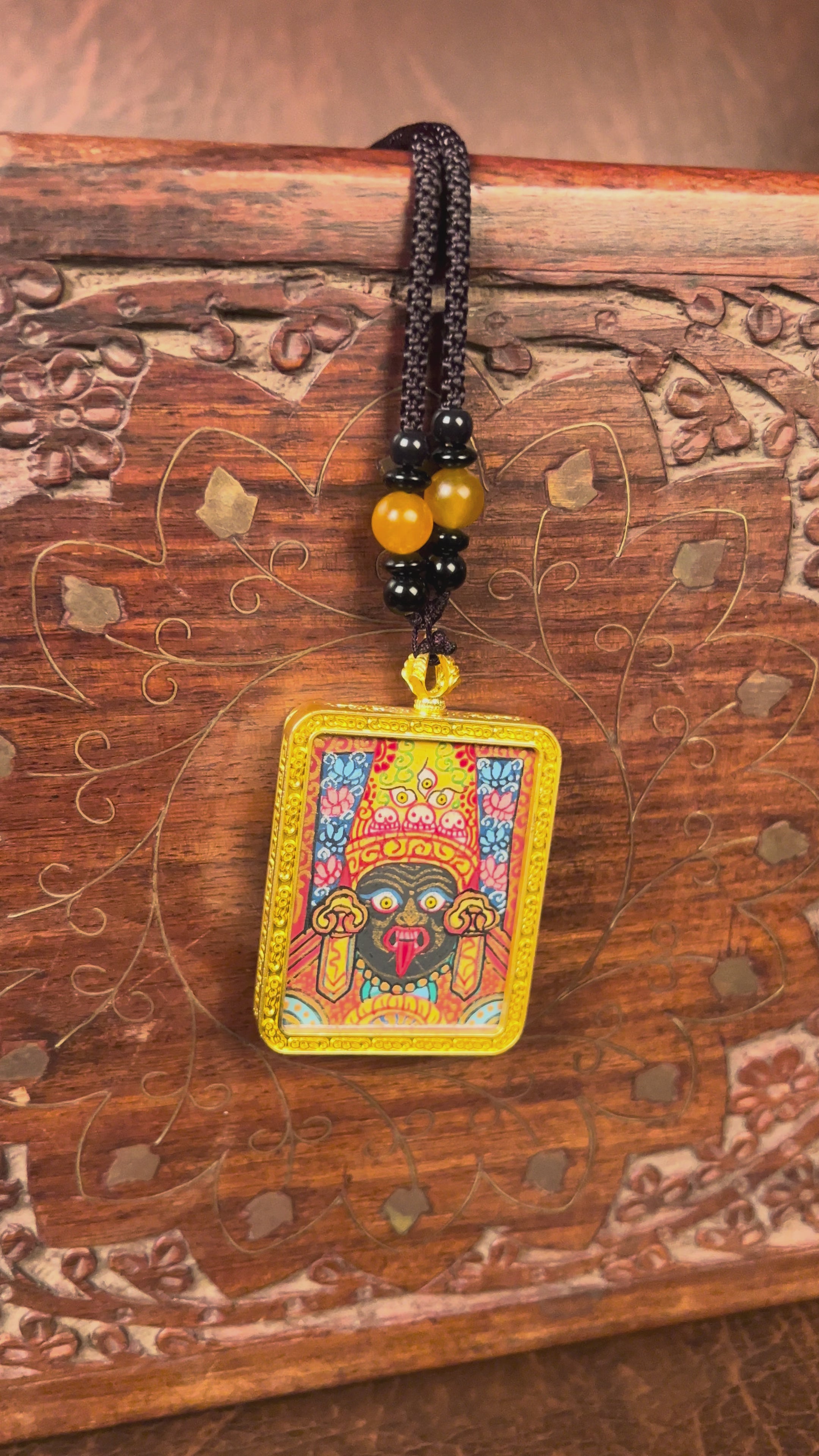 Hand-painted Goddess Kali miniature Thangka pendant in gold-accented copper Ghau locket with black beaded cord.