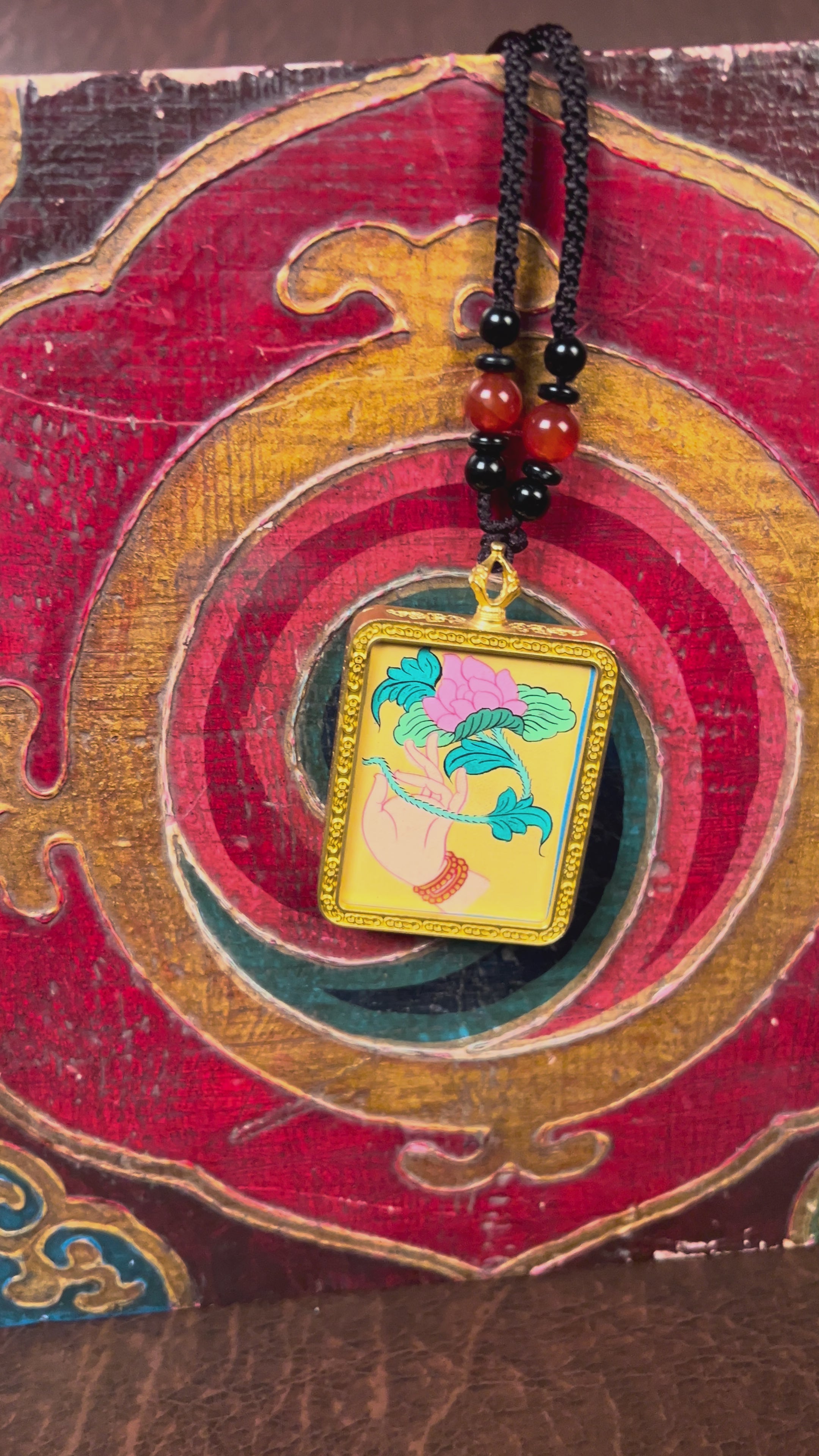 Hand-painted lotus flower in sacred hand miniature Thangka pendant inside gold-accented copper Ghau locket with black beaded cord.