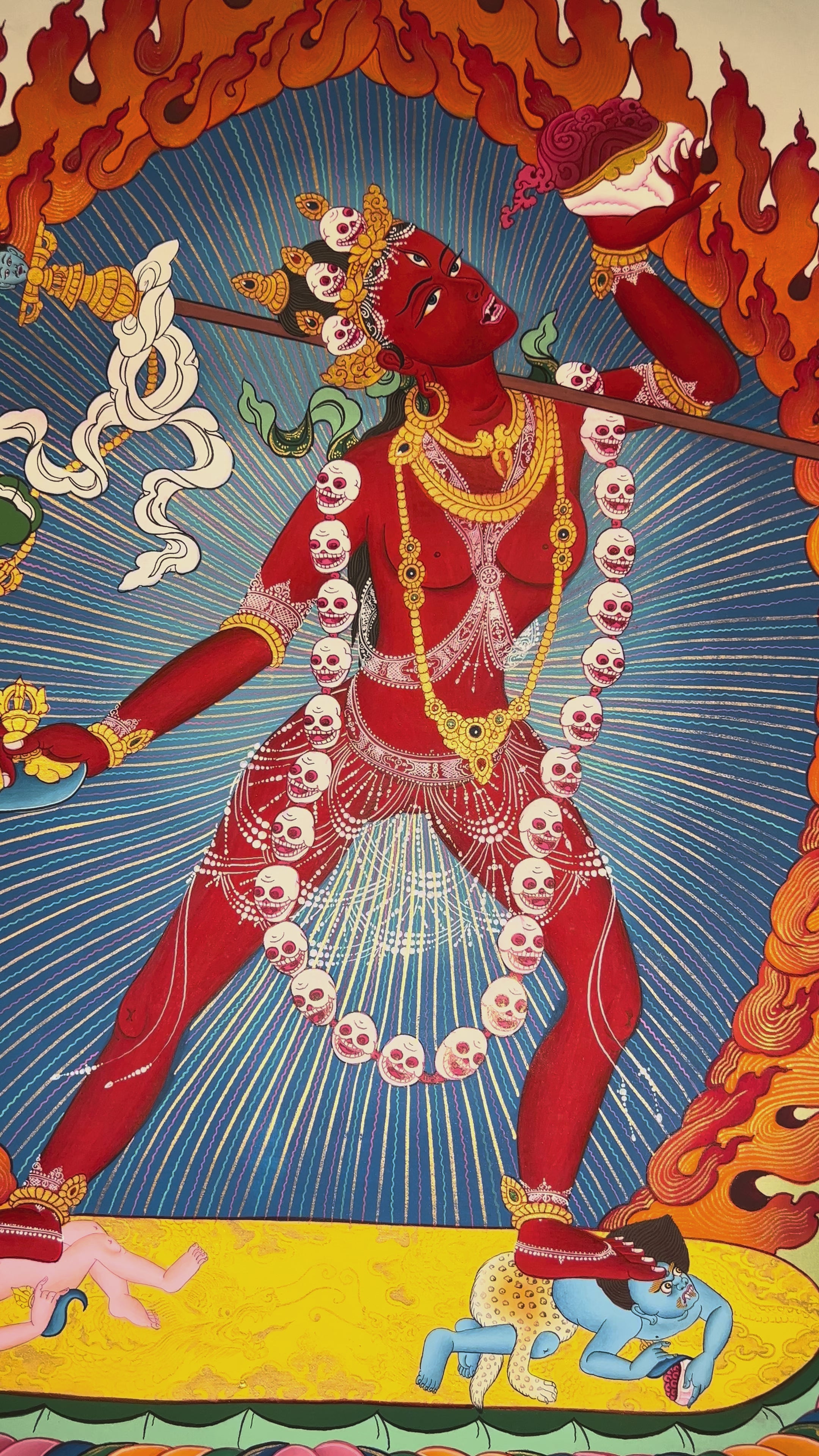 Vajrayogini thangka showing the red tantric dakini dancing with skull garland, holding kapala and ritual knife within a flaming aura.
