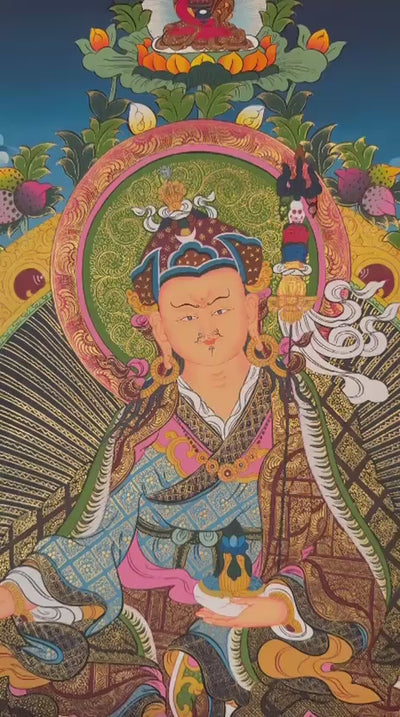 Guru Rinpoche thangka featuring Padmasambhava seated on a lotus throne with sacred tantric symbols and intricate Tibetan gold detailing