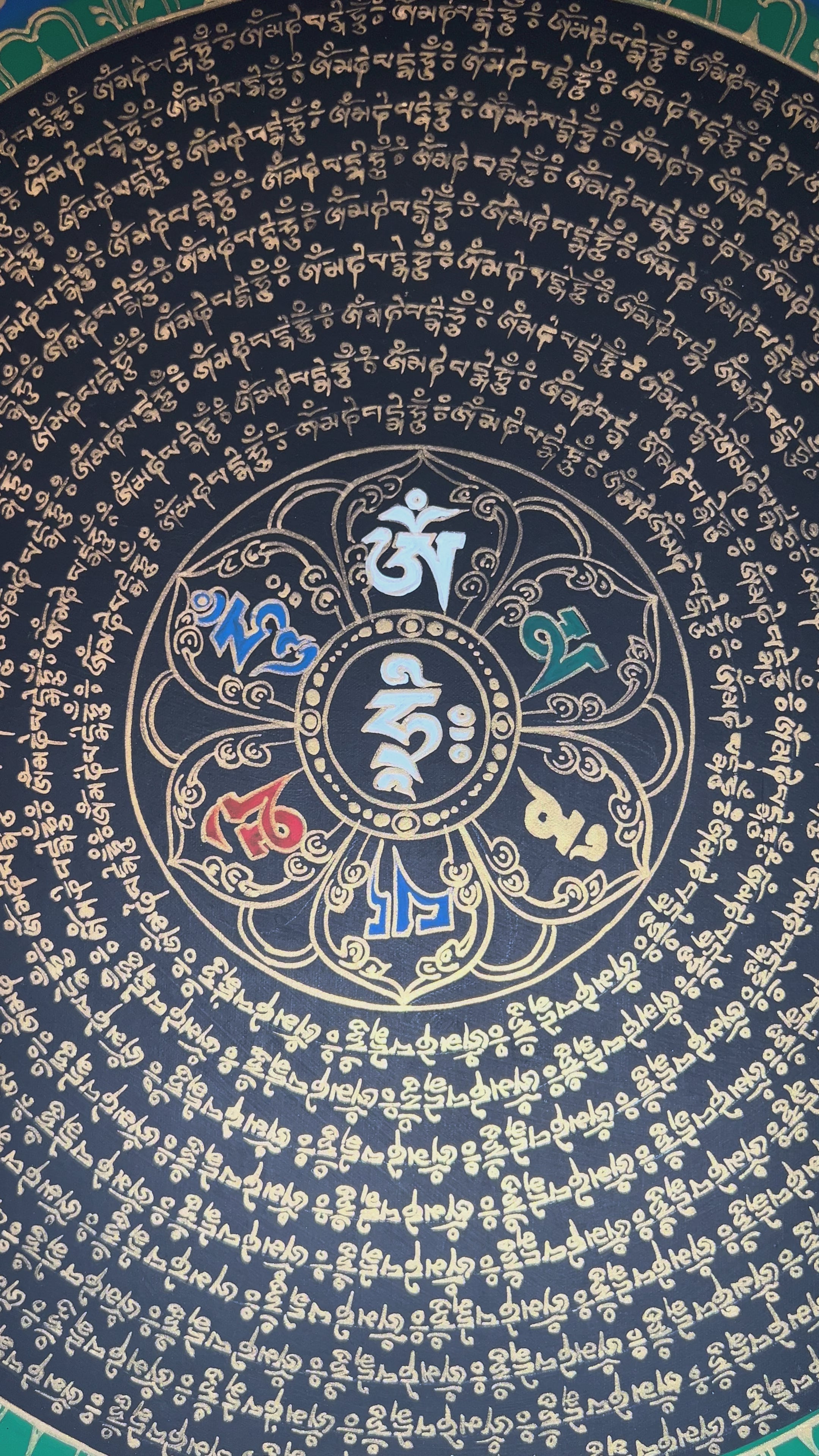 Black background Tibetan mantra mandala thangka with gold concentric script circles and central sacred syllable.