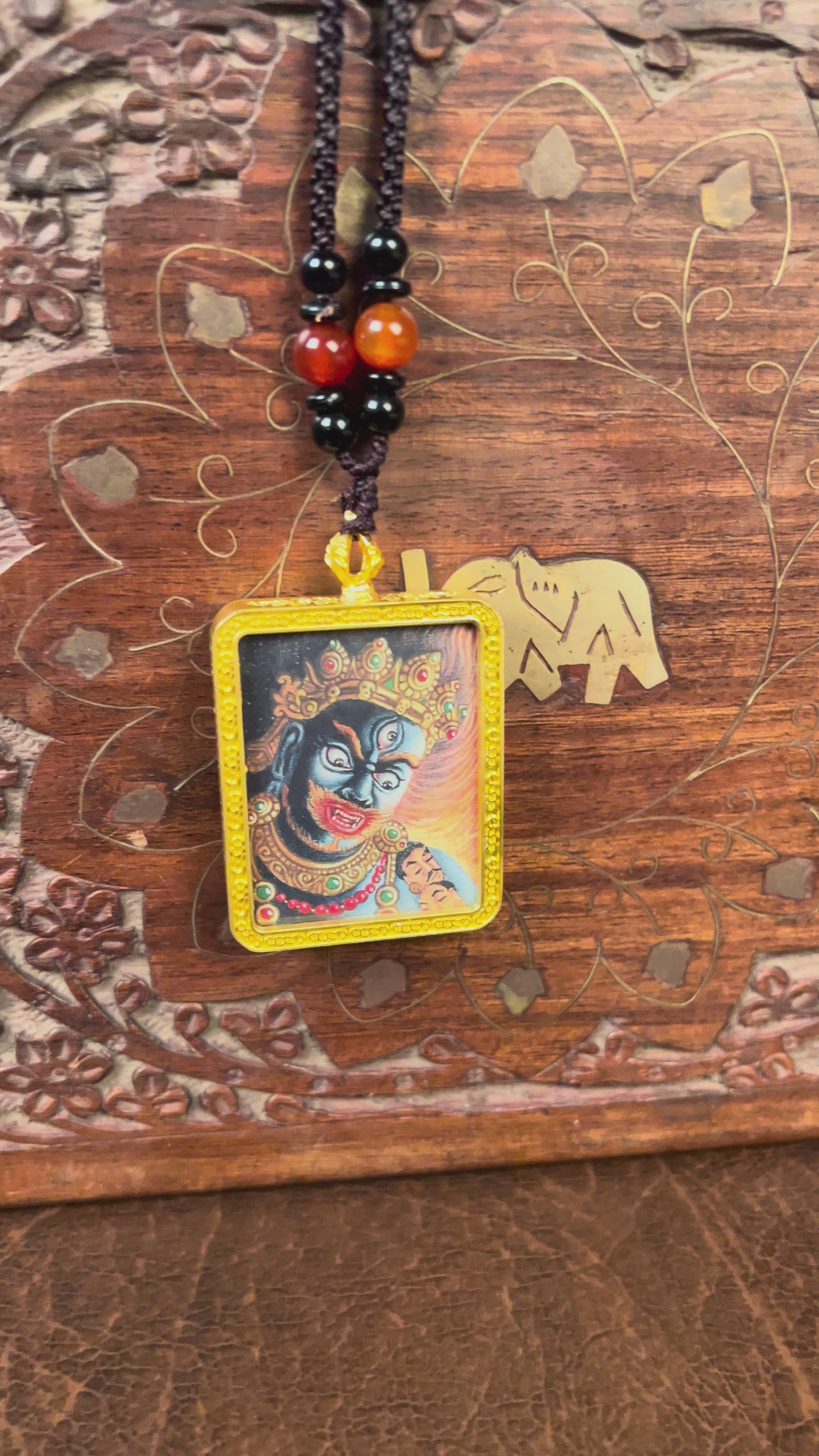 Hand-painted Mahakala miniature Thangka pendant in gold-accented copper Ghau locket with black beaded cord.
