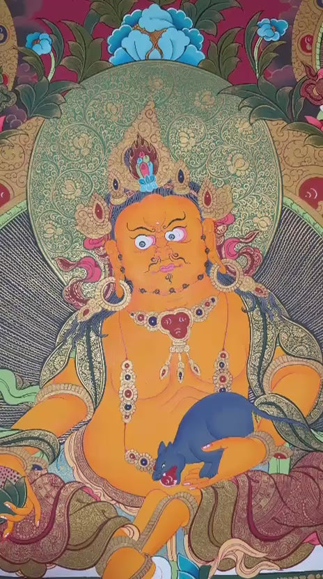 Yellow Zambhala thangka featuring the Buddhist wealth deity holding a jewel-spitting mongoose surrounded by sacred deities and ornate gold detailing on a red background